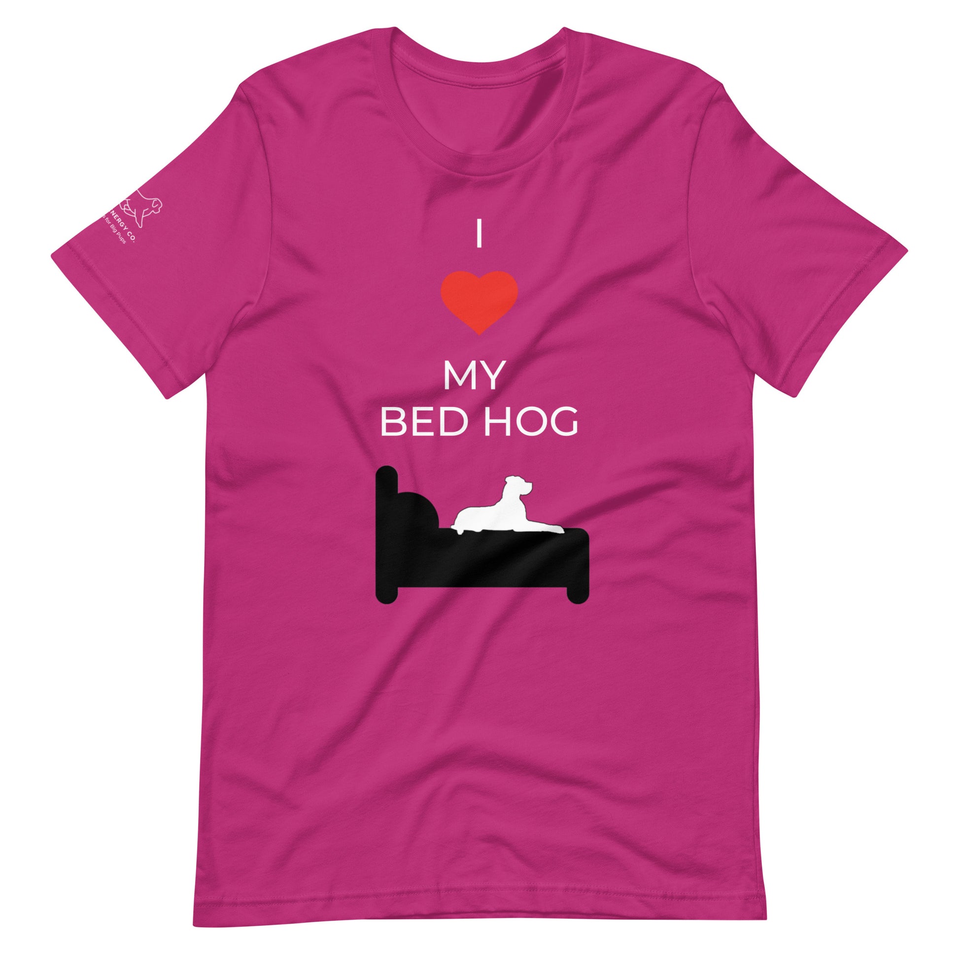 Front of a berry pink t-shirt that reads "I love my bed hog" in white text over an illustration that is the white silhouette of a large dog laying on the dark silhouette of a bed. The word "love" is replaced by a red heart symbol.