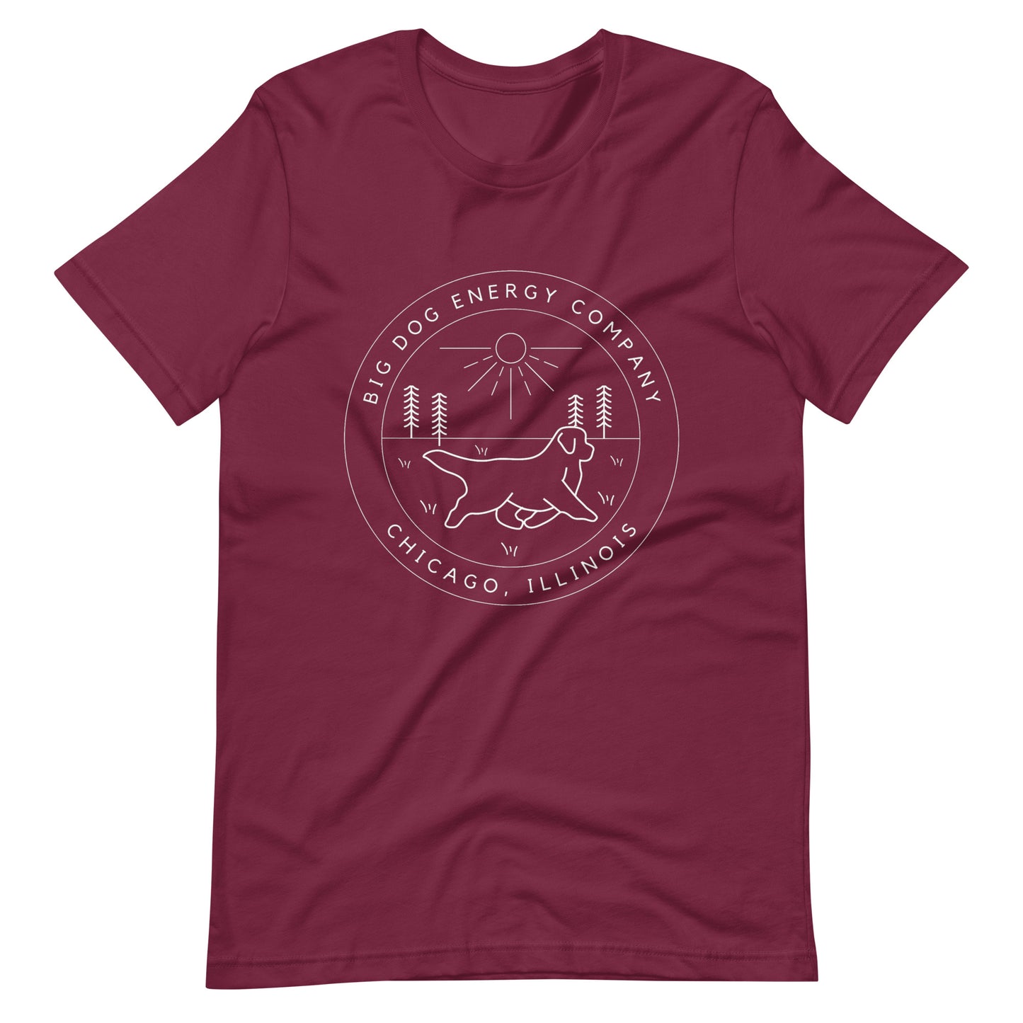 Maroon t-shirt with the Big Dog Energy Company summer camp logo, which is white line art of the outline of a Newfoundland dog trotting through grass with primitive trees and a radiant sun in the background. All of this is encased by two concentric circles, with "Big Dog Energy Company, Chicago, Illinois" wrapped around the inside of the circles and surrounding the logo.