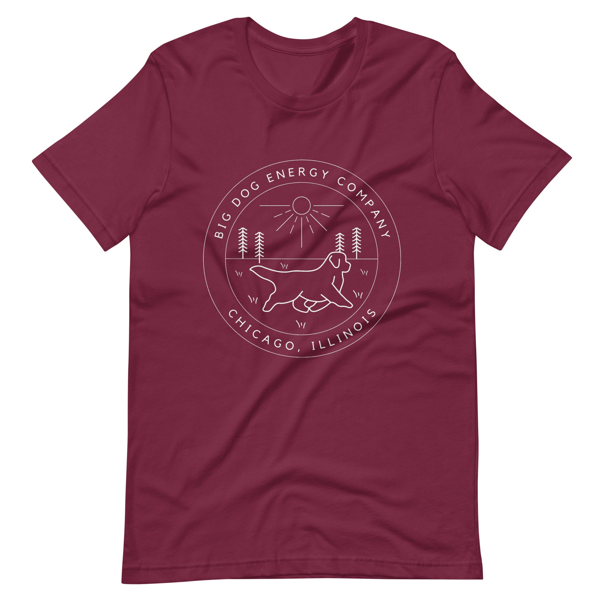 Maroon t-shirt with the Big Dog Energy Company summer camp logo, which is white line art of the outline of a Newfoundland dog trotting through grass with primitive trees and a radiant sun in the background. All of this is encased by two concentric circles, with "Big Dog Energy Company, Chicago, Illinois" wrapped around the inside of the circles and surrounding the logo.