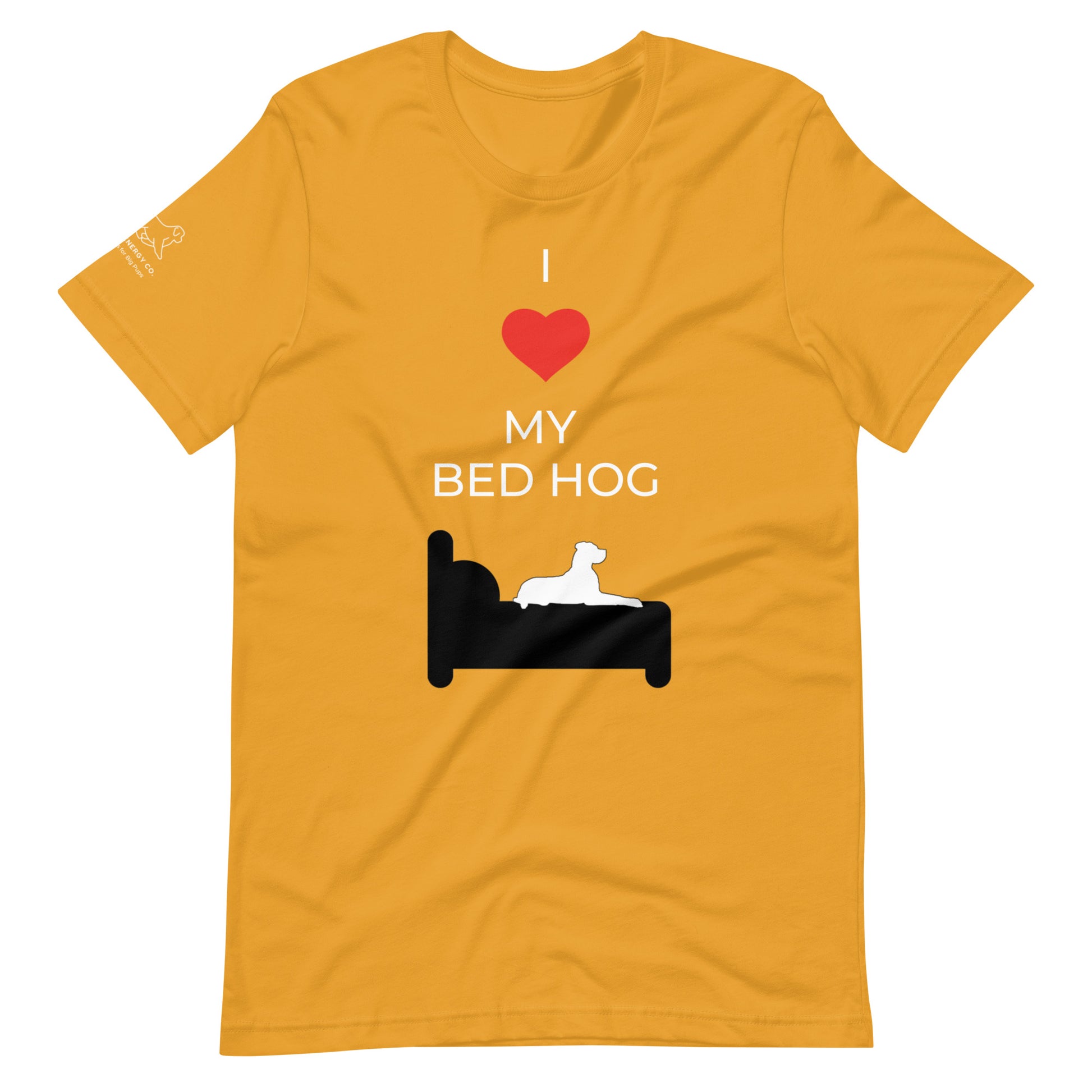 Front of a mustard yellow t-shirt that reads "I love my bed hog" in white text over an illustration that is the white silhouette of a large dog laying on the dark silhouette of a bed. The word "love" is replaced by a red heart symbol.