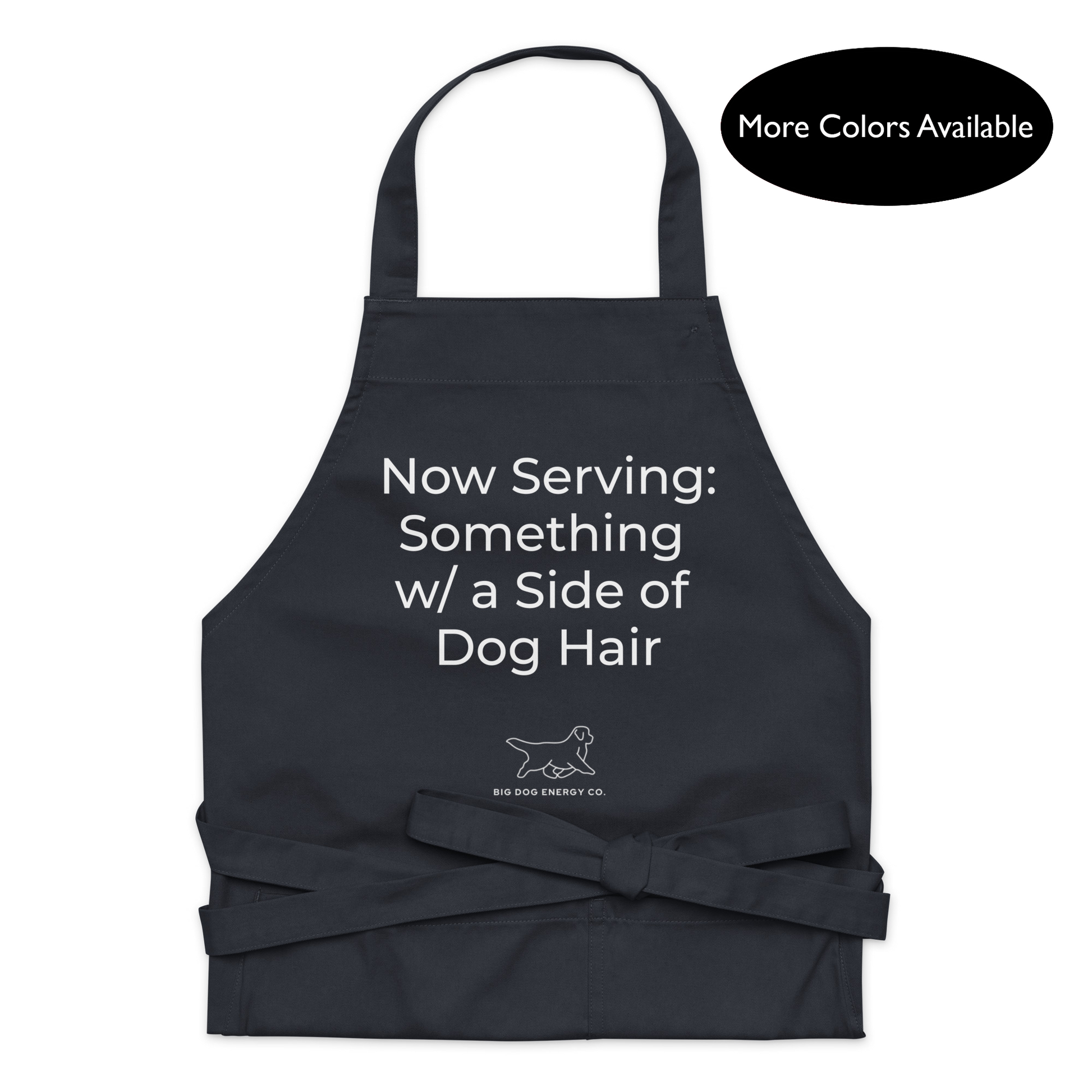 Navy kitchen apron with the saying "Now Serving: Something with a side of dog hair" in white text over a white Big Dog Energy Company logo