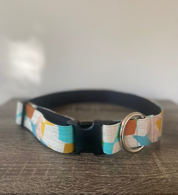 Front view of giant breed dog collar with blue, red, yellow, and green geometric shapes and black plastic buckle.