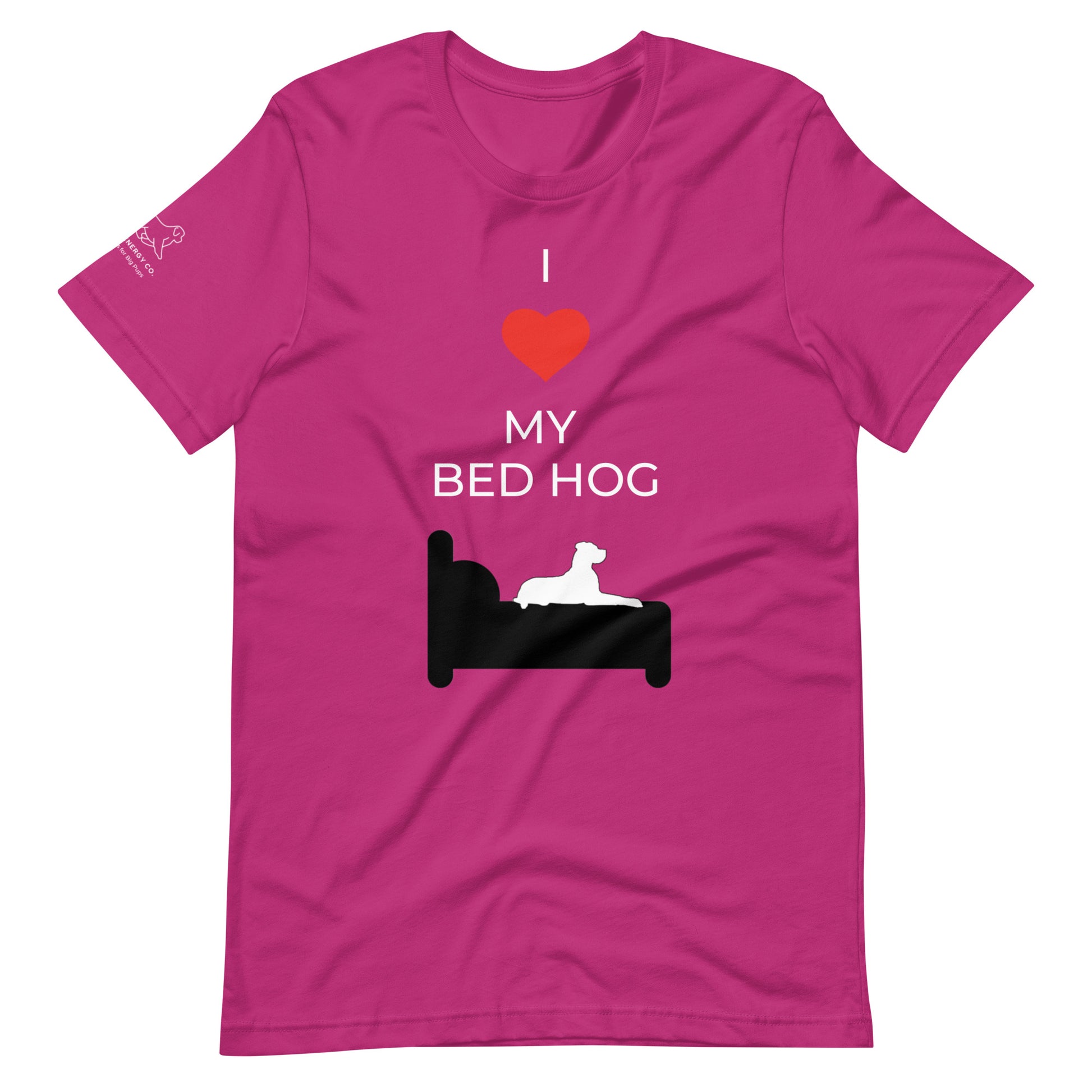 Front of a berry pink t-shirt that reads "I love my bed hog" in white text over an illustration that is the white silhouette of a large dog laying on the dark silhouette of a bed. The word "love" is replaced by a red heart symbol.