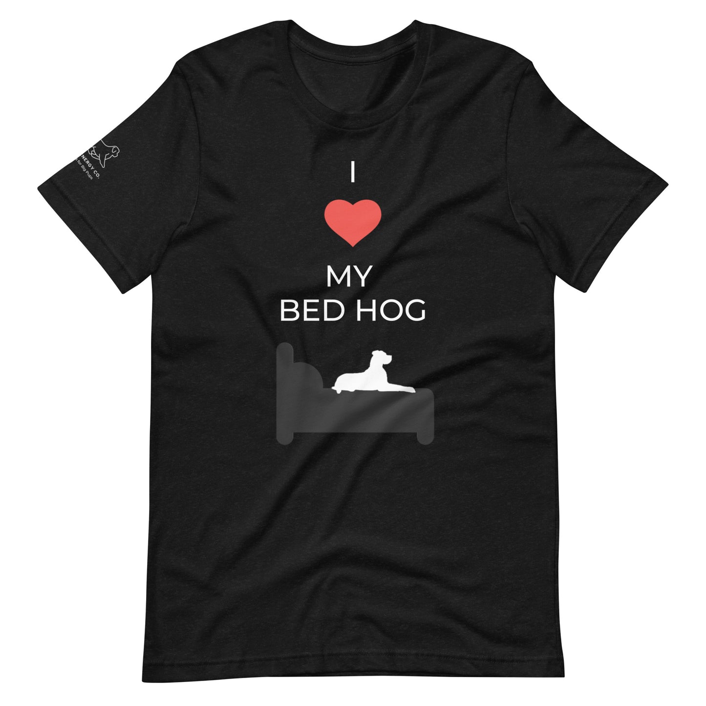 Front of a black t-shirt that reads "I love my bed hog" in white text over an illustration that is the white silhouette of a large dog laying on the gray silhouette of a bed. The word "love" is symbolized by a red heart.
