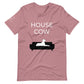 Front of a mauve pink t-shirt that reads "House Cow" in white text over an illustration that is the white silhouette of a large dog laying on the dark silhouette of a couch.