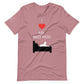Front of a heather orchid pink t-shirt that reads "I love my bed hog" in white text over an illustration that is the white silhouette of a large dog laying on the dark silhouette of a bed. The word "love" is replaced by a red heart symbol.