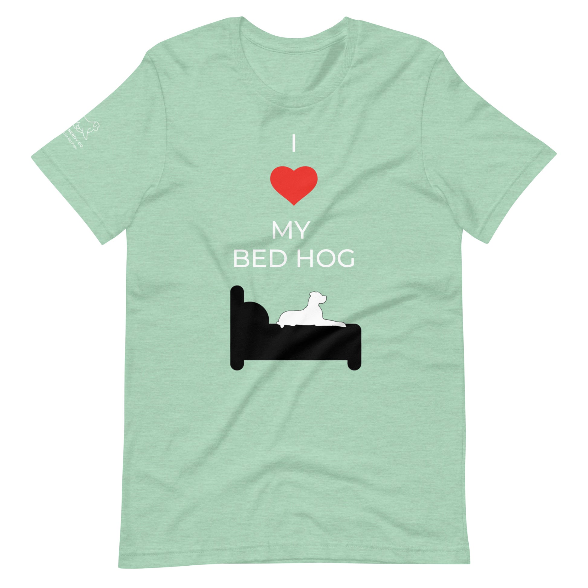 Front of a mint green t-shirt that reads "I love my bed hog" in white text over an illustration that is the white silhouette of a large dog laying on the dark silhouette of a bed. The word "love" is replaced by a red heart symbol.