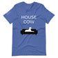 Front of a heather true royal blue t-shirt that reads "House Cow" in white text over an illustration that is the white silhouette of a large dog laying on the dark silhouette of a couch.
