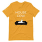 Front of a mustard yellow t-shirt that reads "House Cow" in white text over an illustration that is the white silhouette of a large dog laying on the dark silhouette of a couch.