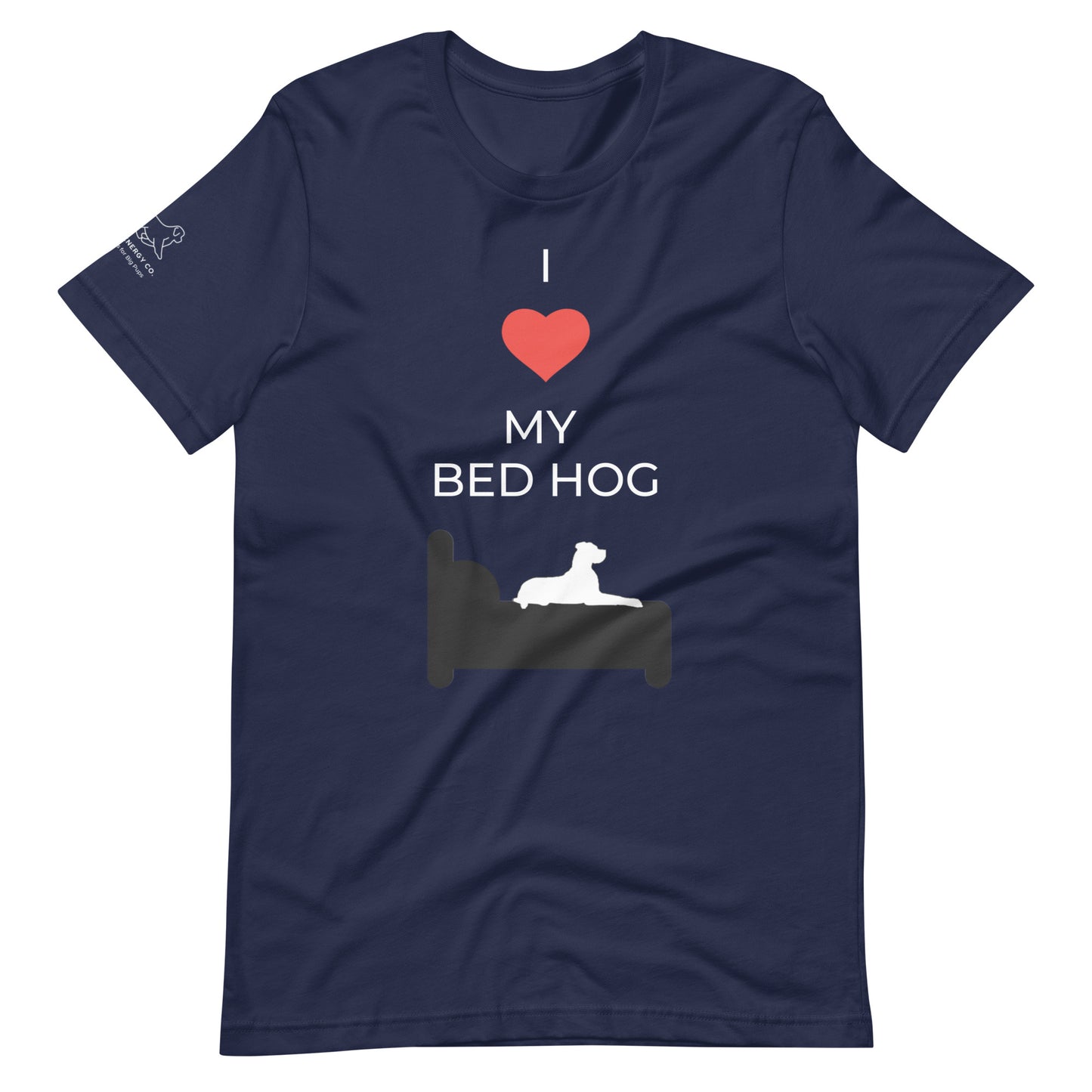 Front of a navy blue t-shirt that reads "I love my bed hog" in white text over an illustration that is the white silhouette of a large dog laying on the deep gray silhouette of a bed. The word "love" is replaced by a red heart symbol.
