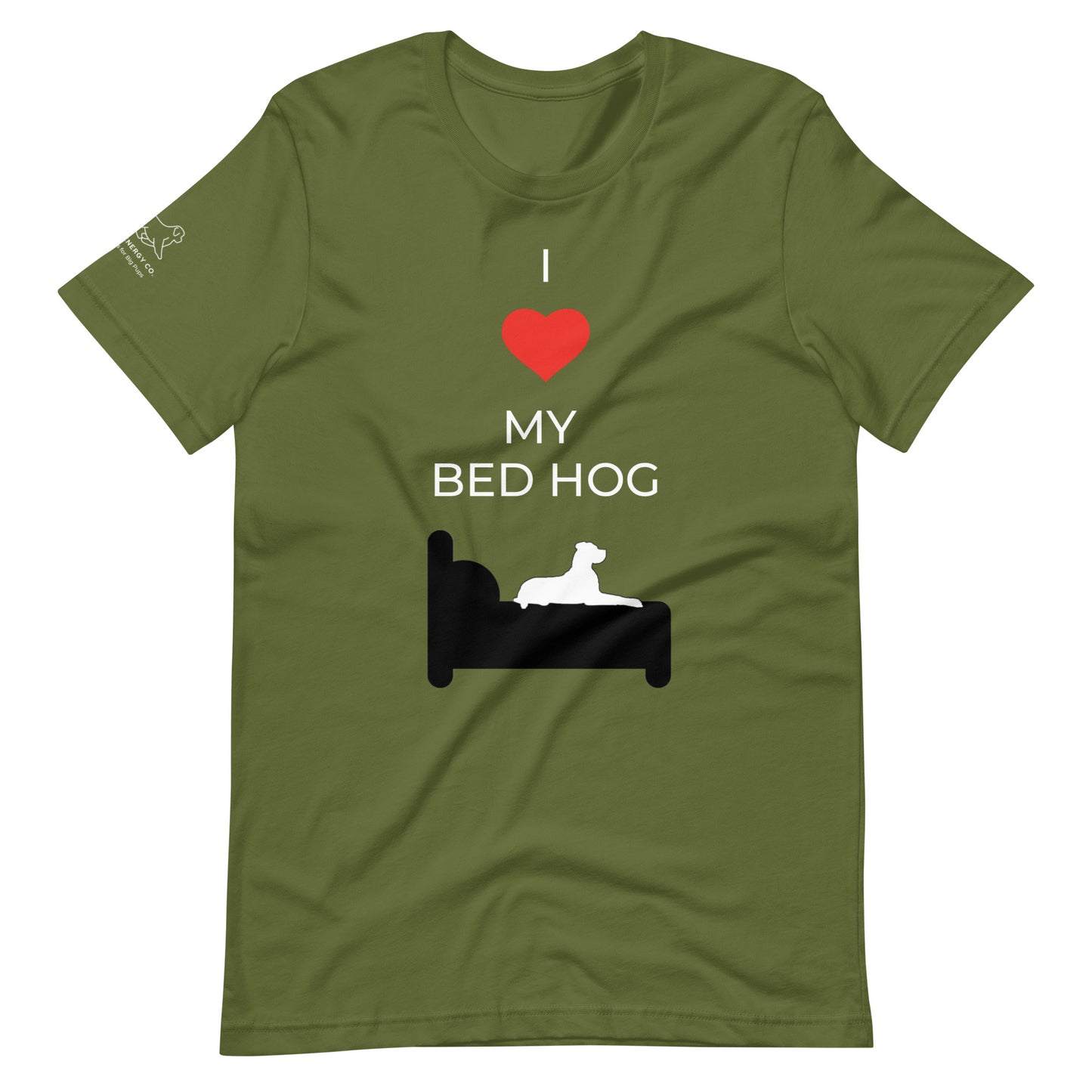 Front of an olive green t-shirt that reads "I love my bed hog" in white text over an illustration that is the white silhouette of a large dog laying on the dark silhouette of a bed. The word "love" is replaced by a red heart symbol.