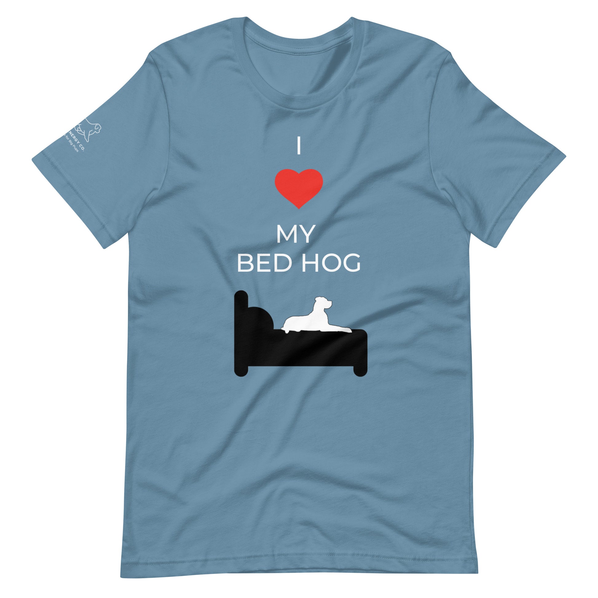 Front of a steel blue t-shirt that reads "I love my bed hog" in white text over an illustration that is the white silhouette of a large dog laying on the dark silhouette of a bed. The word "love" is replaced by a red heart symbol.